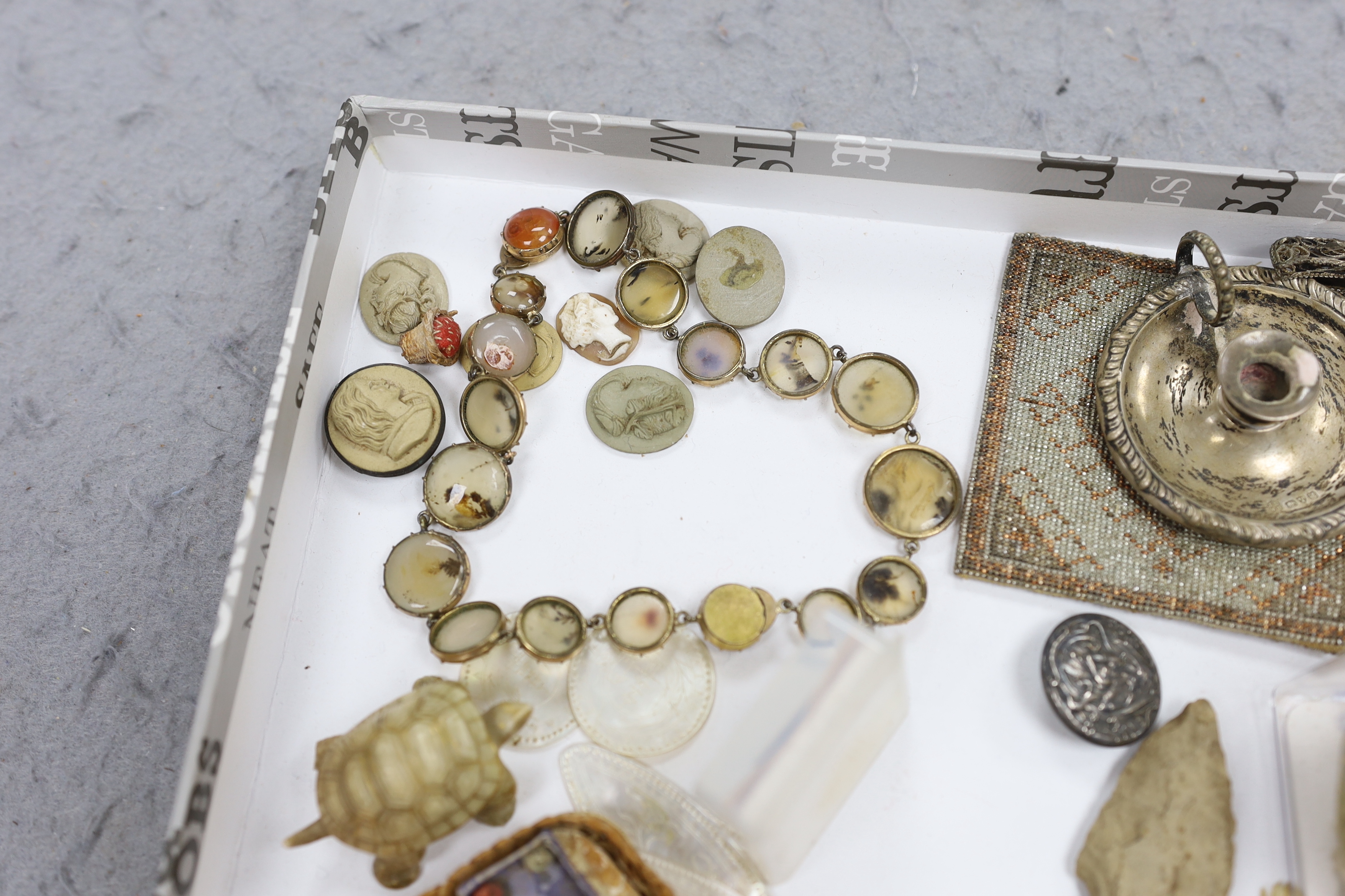 A collection of cabinet curiosities, including carved lava portrait medallions, porcelain scent bottles, etc. (a large quantity)